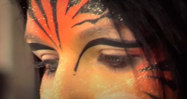Close up of a youth in Alateen with facepaint on, talking to Calum Best in Brought Up By Booze.